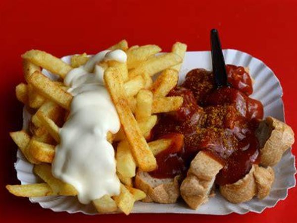 “Currywurst is a fast food dish of German origin consisting of steamed, then fried pork sausage typically cut into slices and seasoned with curry ketchup, a sauce based on spiced ketchup or tomato paste, itself topped with curry powder, or a ready-made ketchup seasoned with curry and other spices. The dish is often served with French fries.”  Wikipedia.