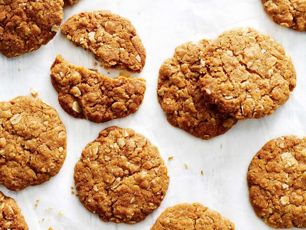 ANZAC biscuits Originating during wartimes, ANZAC biscuits were made during rationing, using whatever materials the people had on hand. They were sent to the Australian and New Zealand Army Corps, or ANZACs, (hence the name) as a gift from families at home to soldiers at war. They are made with rolled oats, flour, sugar, butter, golden syrup, baking soda, boiling water, and desiccated coconut.