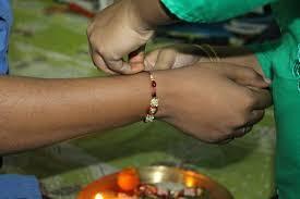 What is the Indian festival where sisters tie a protective thread called 'Rakhi' around their brothers' wrists?