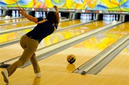 What is it called when a bowler knocks down all ten pins with the first ball?