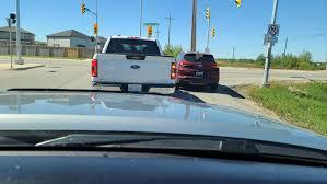 How often should you perform a shoulder check in heavy city traffic?