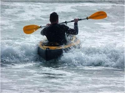 What does the term 'edging' refer to when kayaking?