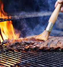 What is the purpose of basting meat while grilling?