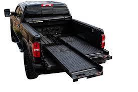 What is a benefit of using a cargo slide in a truck bed?