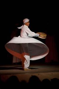 Which Sufi practice involves spinning around in repetitive circles?