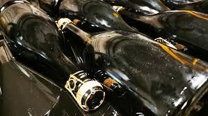 What process involves rotating sparkling wine bottles to move sediment toward the neck?