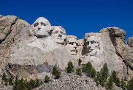 Which famous sculpture features four American presidents at Mount Rushmore?