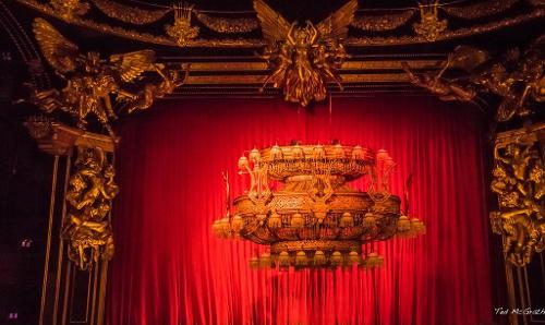 Which theater is famous for its grand chandelier and phantom?