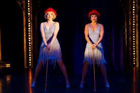 Which musical involves the characters Roxie Hart and Velma Kelly?