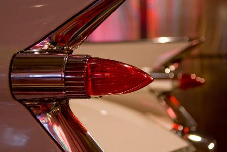 What classic car is known for its distinctive fins and rocket-inspired tail lights?