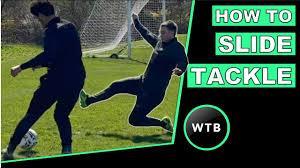 What is the main objective of a slide tackle?