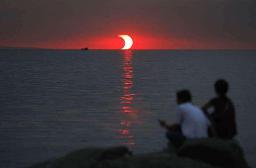 An eclipse and sunset happening at the same time